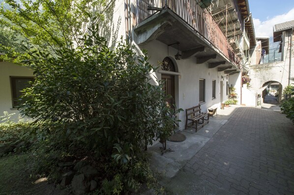 Stroll through the serene courtyard surrounded by lush greenery and traditional architecture.