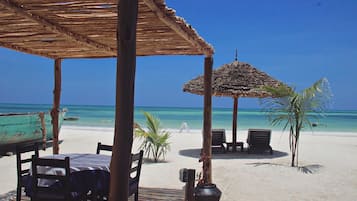 En la playa, sillas reclinables de playa, sombrillas, buceo