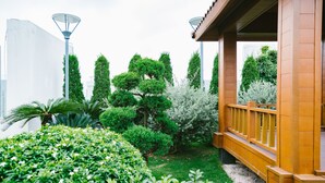 A garden with various shrubs and a wooden fence. - Park Hill No1 Apartment (Hanoi)