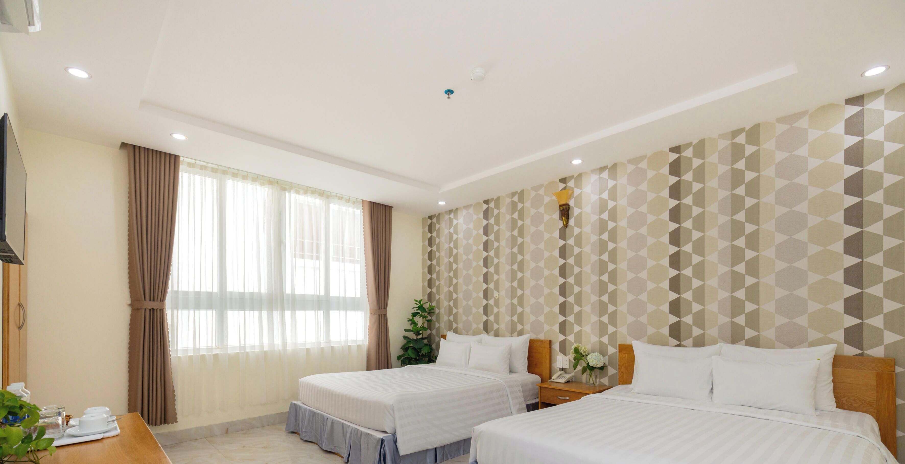 Deluxe Quadruple Room, City View | Minibar, desk, free WiFi, bed sheets