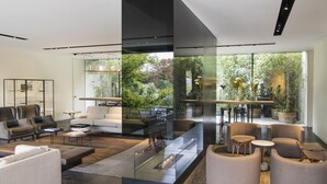 Una sala de estar moderna con chimenea de vidrio, asientos cómodos y vistas a un jardín exuberante.