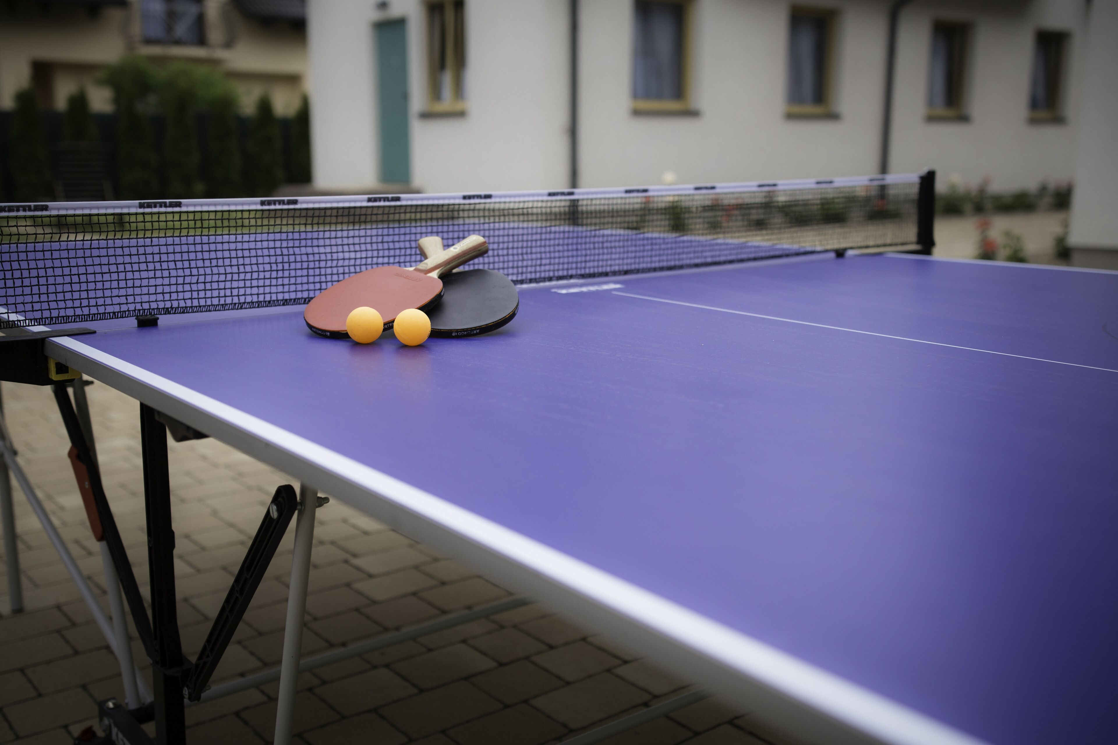 Une table de ping-pong avec des raquettes et des balles.