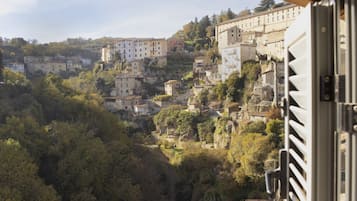 Un village perché sur une colline, avec des bâtiments traditionnels en pierre, dont certains sont dotés de balcons, et un mélange de logements et, peut-être, de commerces.