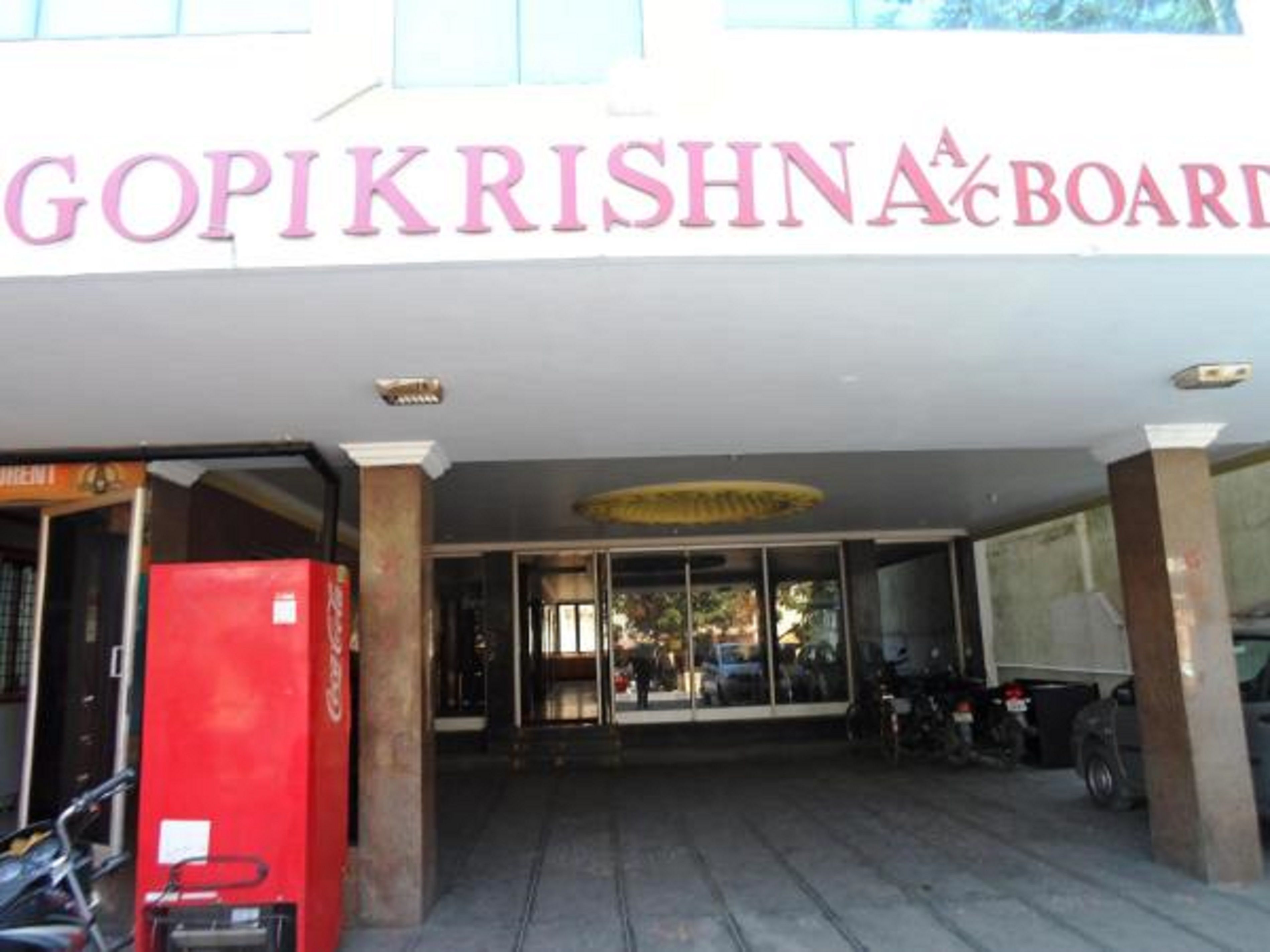 The entrance to a building with a sign reading "GOPIKRISHNA BOARD".