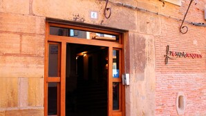 A wooden door with a glass panel, a number '4' sign above it, and a sign reading 'P.SADAIGNATUS' on the adjacent wall. - Pensión Posada Ignatius (Navarrete)