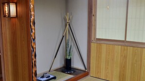 A traditional Japanese room with tatami flooring, a low wooden table, a shoji screen, and a hanging lamp. - Ho-ma ya (Ishigaki)