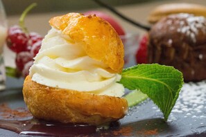 A dessert with whipped cream and fruit on a pastry, garnished with mint. - La Chaumière (Aubigny-sur-Nere)