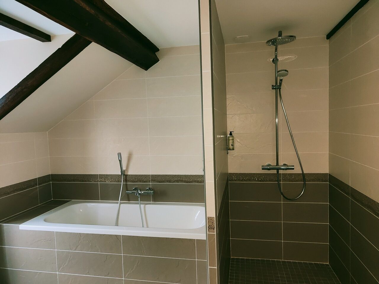 A bathroom with a bathtub and a shower.