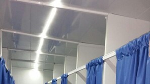 A row of blue curtains in a hallway, likely leading to private rooms or suites. - Camelot (Villarrobledo)