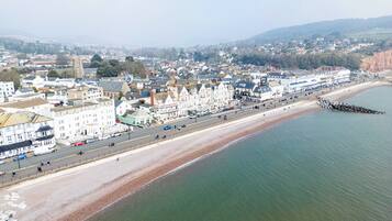 A coastal town with a wide promenade, historic buildings, and a prominent church.