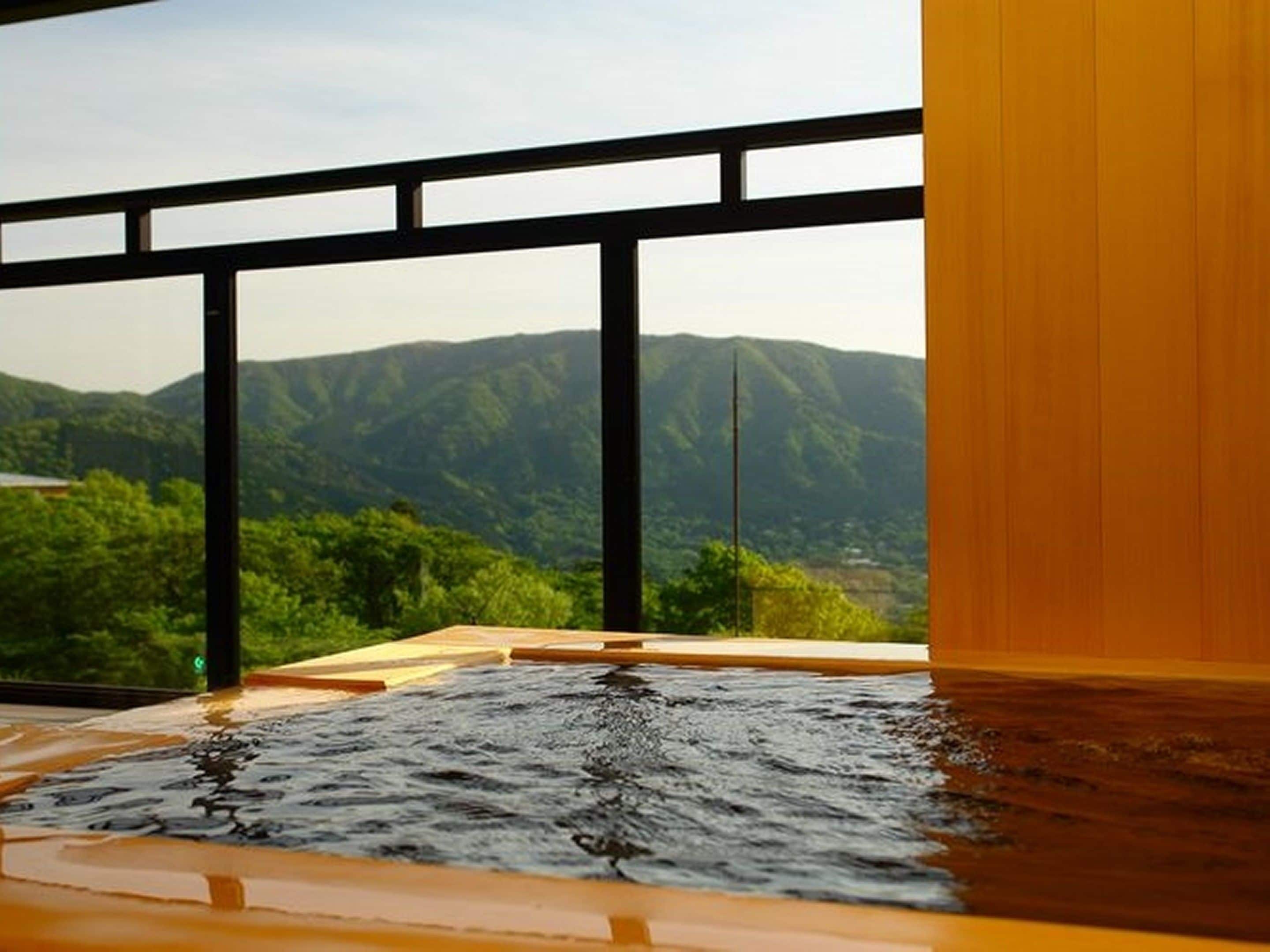 A hot tub with a view of mountains through large windows.