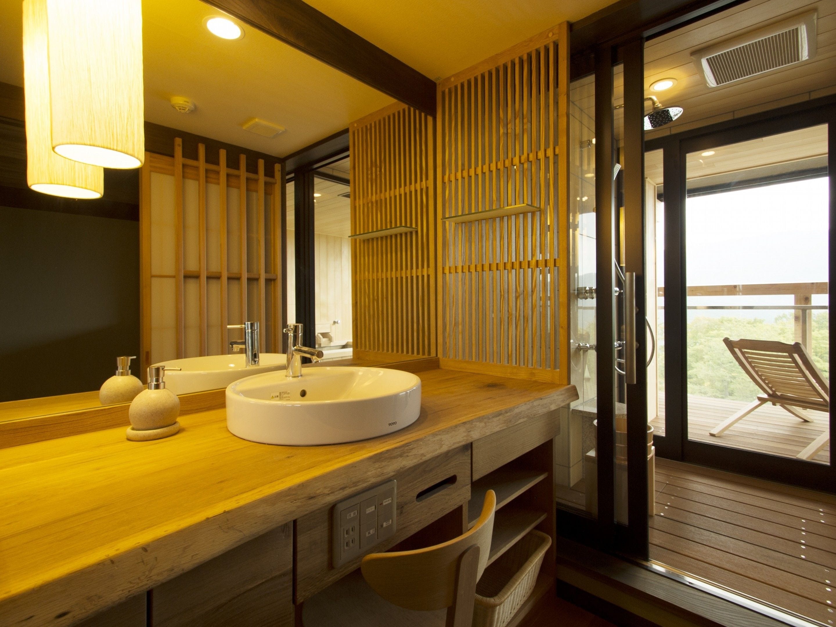 A modern bathroom with a wooden vanity, two sinks, and a large mirror.