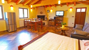 A spacious living area with a dining table, sofa, and a bed. - Apartment Tatjana 411 (Medulin)