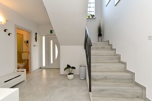 A modern interior with a staircase, a white toilet, and a potted plant. - Apartment Silva 611 (Medulin)