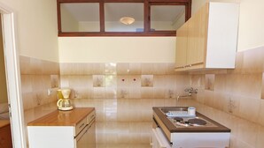 A compact kitchen with a sink, a coffee maker, and a stove. - Apartments Celine 606 (Medulin)