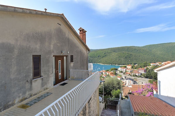 A coastal town with a view of the sea and hills.