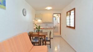 Un espai vital reduït amb zona de dinar, petita cuina i bany.