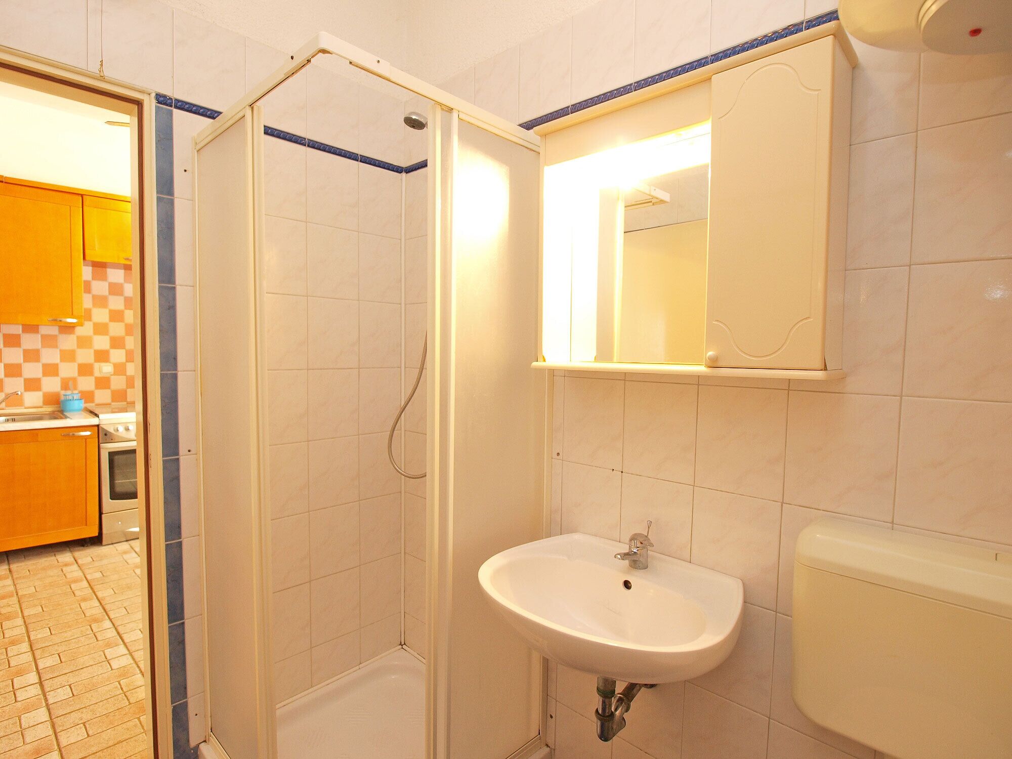 A bathroom with a shower, sink, and toilet.