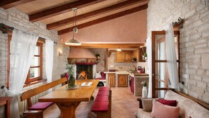 A cozy kitchen with wooden beams, stone walls, and a fireplace. - Apartments Valter 881 (Novigrad)