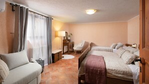 A cozy bedroom with a bed, a sofa, a desk, and a chair. - Apartments Valter 881 (Novigrad)