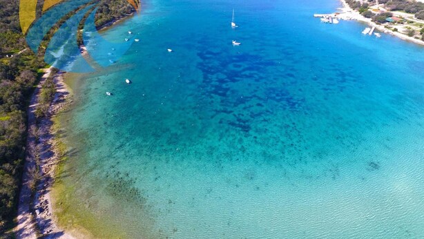 An aerial view of a coastal area with clear blue waters, boats, and a small island. - Rooms Milan 1370 (Rovinj)