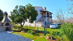 A two-story house with a balcony, a stone fireplace, and a fenced garden. - Apartments Marta 1066 (Rovinj)