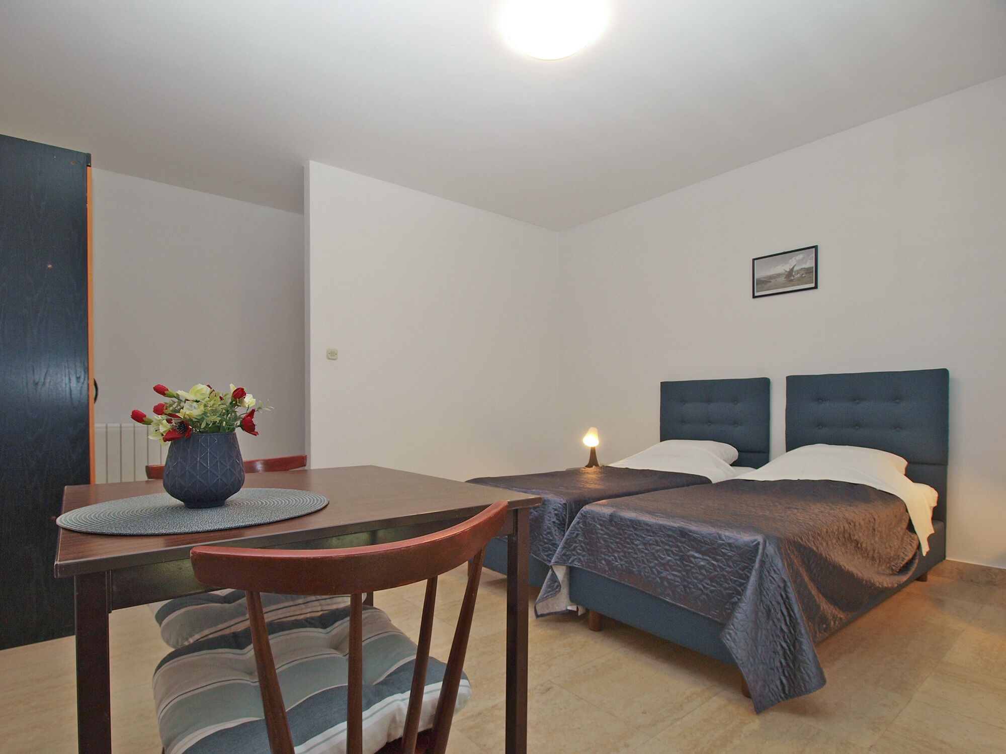 Une chambre à coucher avec un lit, une table de chevet et une chaise.