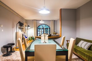 A dining area with a glass table, chairs, and a ceiling fan. - Apartments Graziella 992 (Pula)
