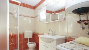 A bathroom with a shower, toilet, sink, and mirror. - Apartments Jacqueline 1227 (Medulin)