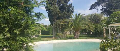 Seasonal outdoor pool, open 9:00 AM to 8:00 PM, pool umbrellas