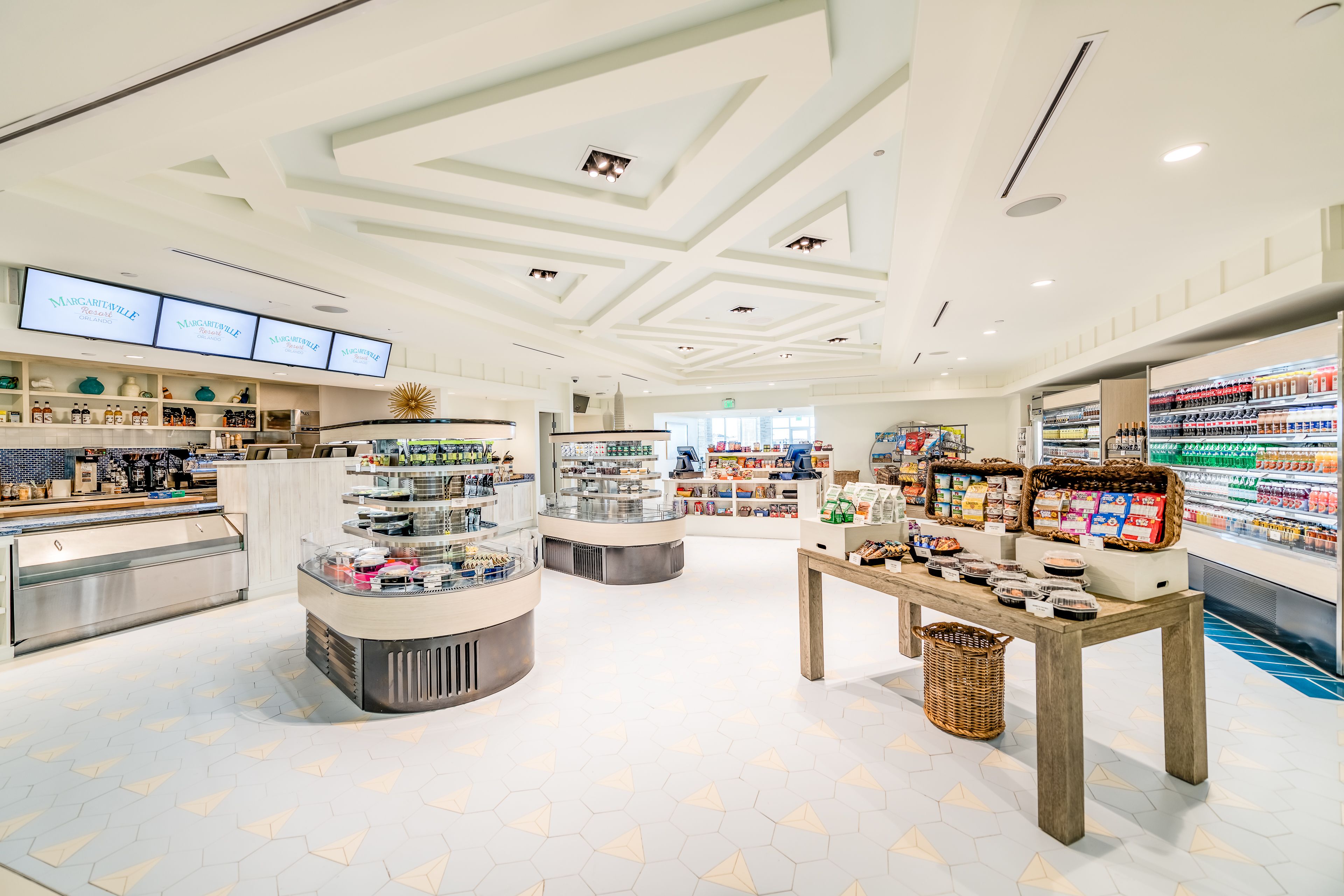 A modern retail store with a central display area, shelves stocked with products, and a checkout counter.