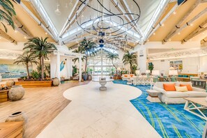 A spacious lobby with a high ceiling, wooden beams, and a central fountain. - Margaritaville Resort Orlando with H2O Waterpark (Kissimmee)