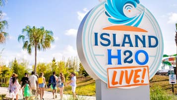A sign with "ISLAND H2O LIVE!" and a wave design.