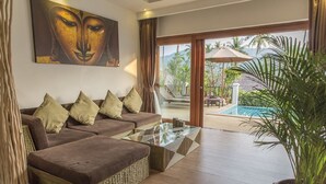 A modern living room with a sofa set, a glass coffee table, and a large window offering a view of a pool and outdoor area. - Tropical Season Villa Resort (Koh Samui)