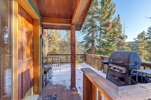 A wooden deck with a barbecue grill, outdoor seating, and a view of trees. - 72 Clubhouse Rd Private Home with Hot Tub (Breckenridge)