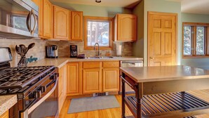 A modern kitchen with wooden cabinets, stainless steel appliances, and a large island. - 72 Clubhouse Rd Private Home with Hot Tub (Breckenridge)
