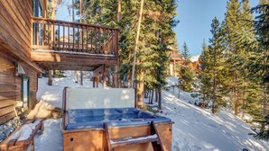 A wooden cabin with a hot tub, wooden deck, and snow-covered ground. - 72 Clubhouse Rd Private Home with Hot Tub (Breckenridge)