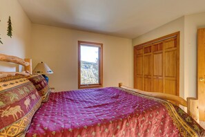 A bedroom with a large bed, a window, and a wooden wardrobe. - 72 Clubhouse Rd Private Home with Hot Tub (Breckenridge)