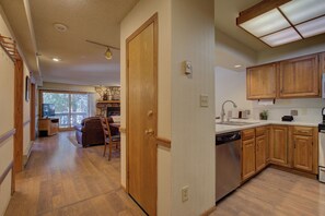 A spacious kitchen with wooden cabinets and a dishwasher.