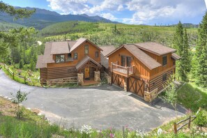 A log cabin with a stone foundation, wooden exterior, and a balcony. - Cloud Peak Vista Peak 7 Private Home with Hot Tub (Breckenridge)