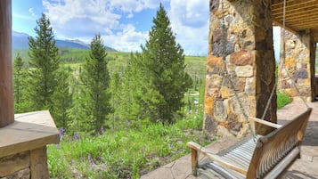 A stone bench with a view of a mountainous landscape.