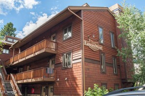 A multi-story wooden building with balconies and a sign reading "Lances Vest." - Lance's West 6 Condo with Pool & Hot Tub (Breckenridge)