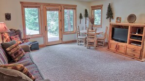 A living room with a sofa, chairs, a TV stand, and a fireplace. - Moose Meadow Retreat Private Home with Hot Tub (Breckenridge)