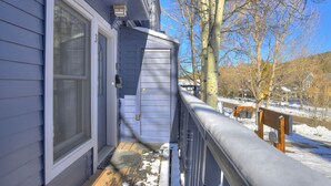 A wooden deck with snow on the ground, a metal railing, and a clear blue sky. - Wellington #3 (Townhome with Private Hot Tub) (Breckenridge)