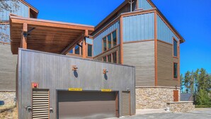 A two-story building with a garage entrance and a clear sky. - Atrium 207 Downtown Condos with on-site Hot Tub (Breckenridge)