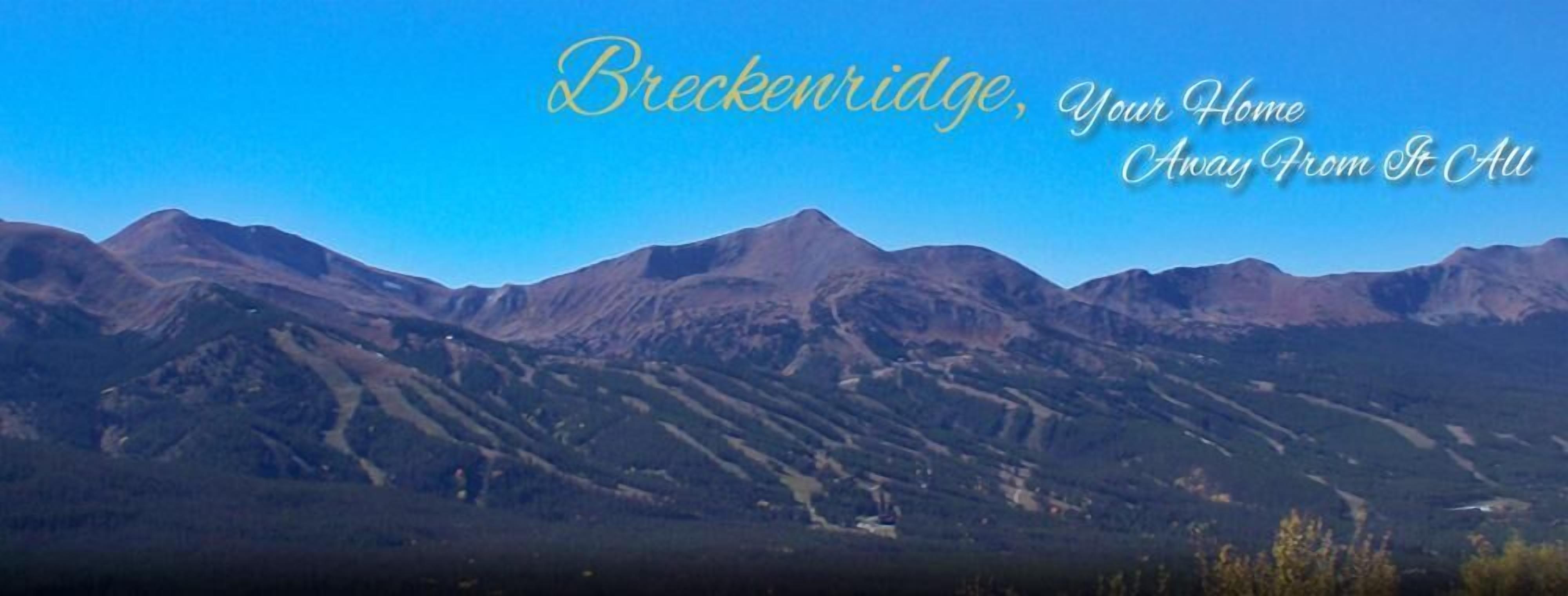 A mountainous landscape with the text "Breckenridge, Your Home Away From It All".