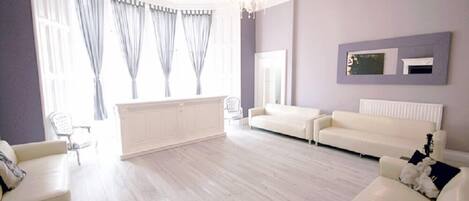 Townhome (Princes Street Sleeps 30 People) | Living area | Flat-screen TV