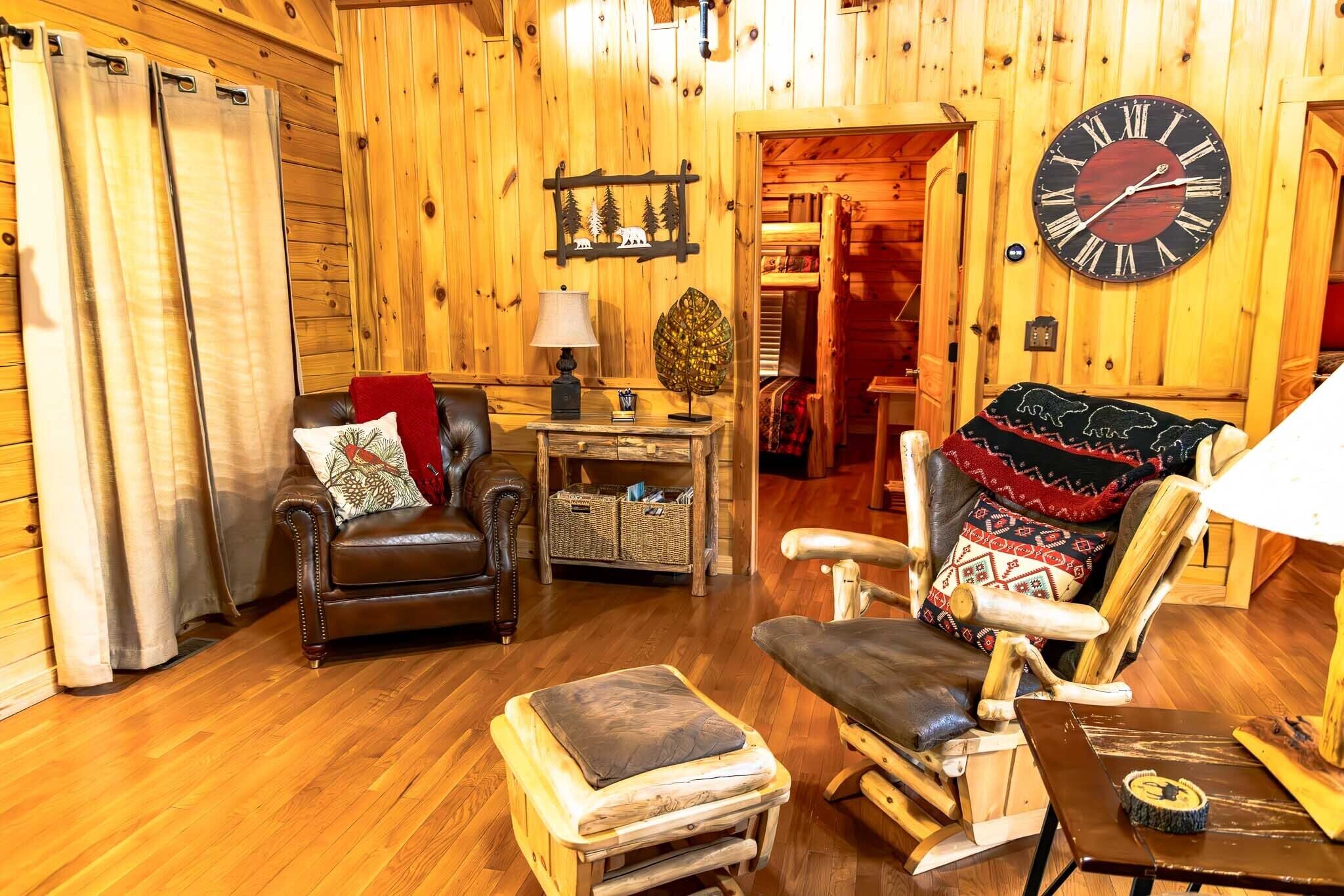 A cozy cabin interior with a wooden interior, leather furniture, and a large wall clock.