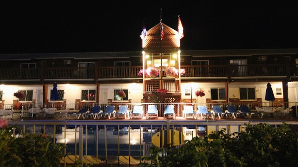 A hotel with a central tower, multiple balconies, and a pool area. - Sea Drift Motel (Old Orchard Beach)