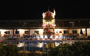 A hotel with a central tower, multiple balconies, and a pool area. - Sea Drift Motel (Old Orchard Beach)